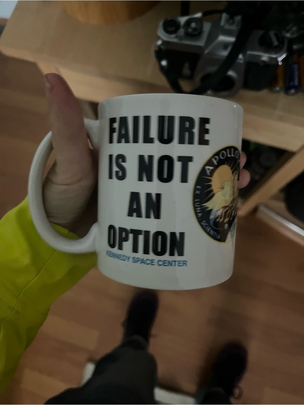 Ceramic coffee mug says  "Failure is Not an Option" with "Kennedy Space Center"